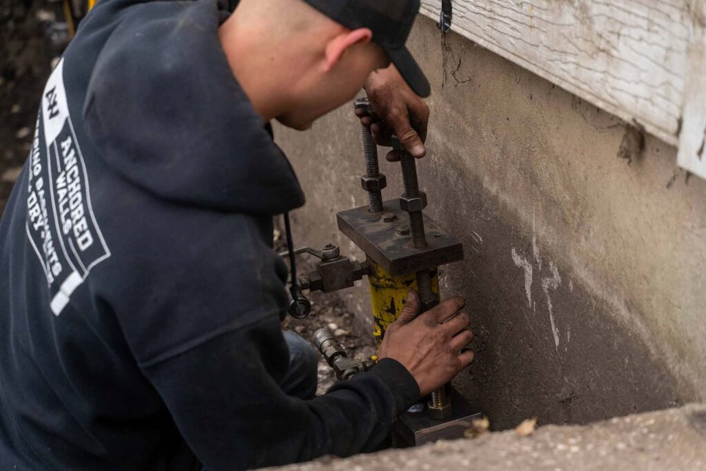 Close picture of man using tools for foundation repair
