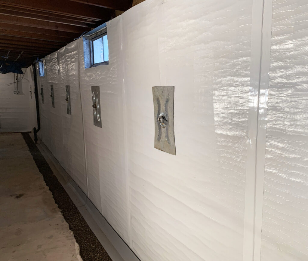 Wall anchors on a waterproofed wall